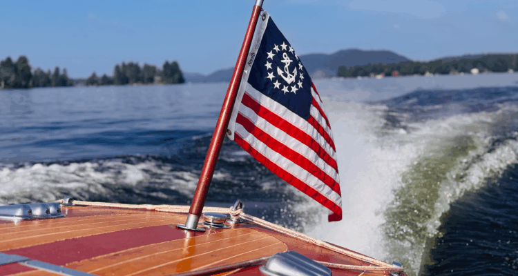 Yacht Ensign of the United States on the stern of a boat in an Adirondack lake